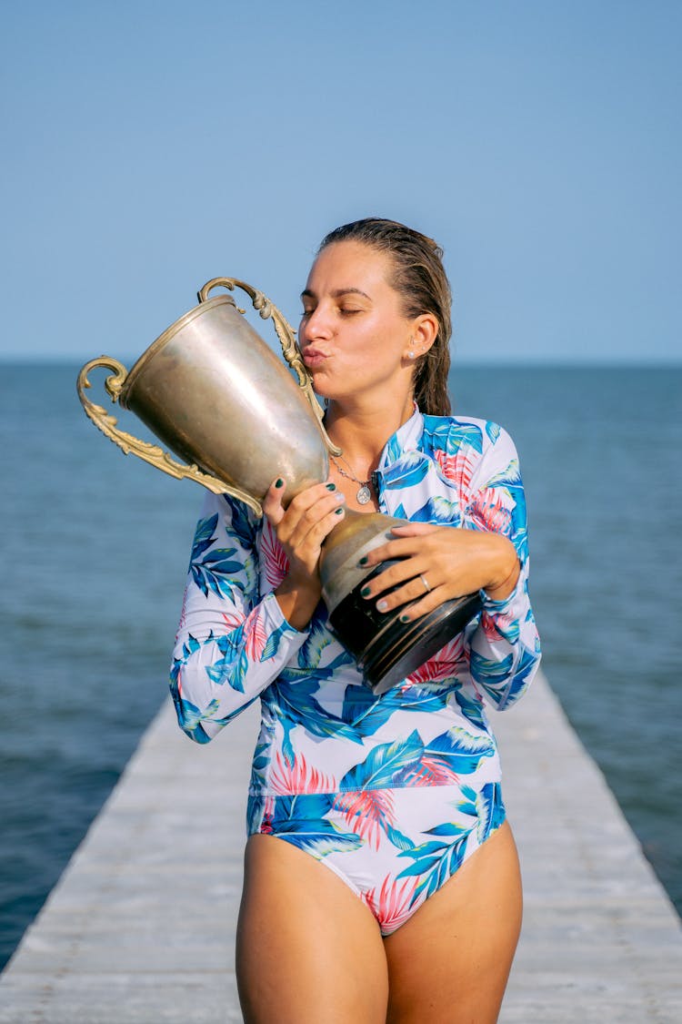 A Woman Holding A Trophy