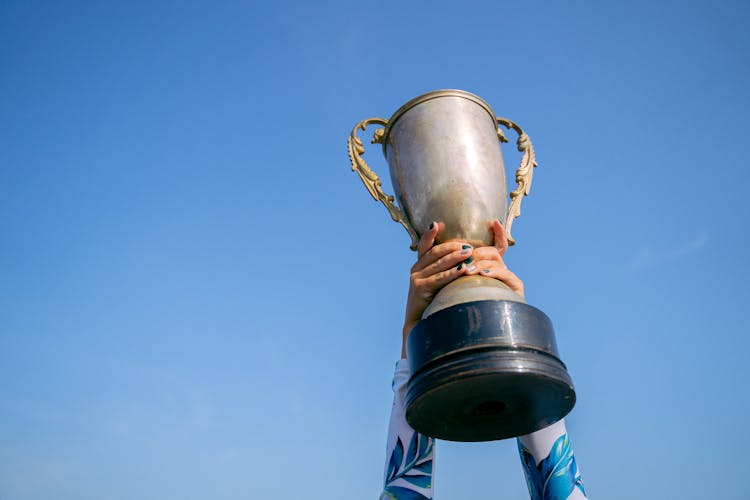 A Person Holding A Trophy