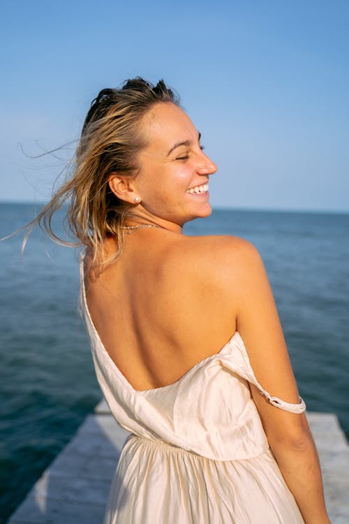 
A Smiling Woman Wearing a White Dress