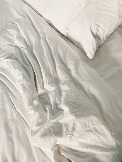 Free White Pillow and Bed Sheet  Stock Photo