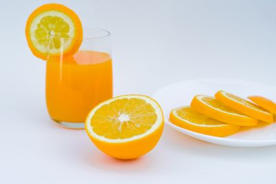 A glass of freshly pressed orange juice with citrus slices. Photo by Tymur Khakimov on Pexels