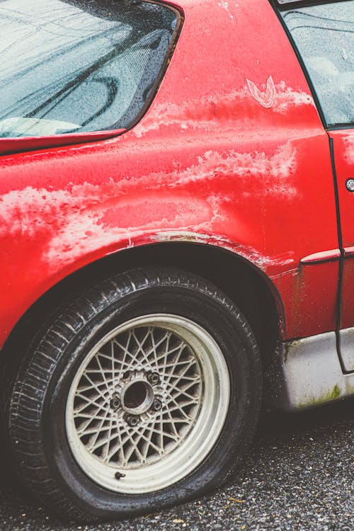 Free A Red Car With a Flat Tire Stock Photo