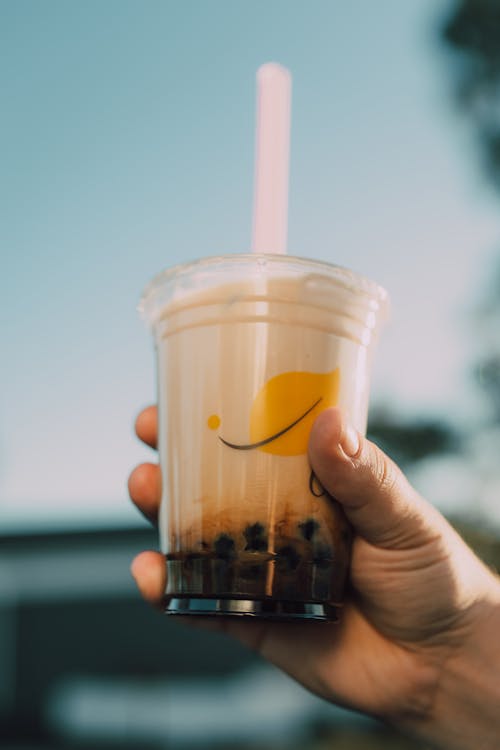 Free A Person Holding a Milk Tea Stock Photo