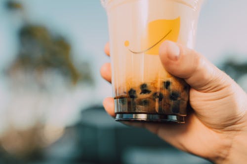 a Close Up Shot of a Person Holding a Milk Tea