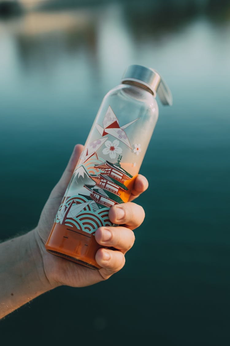 Person Holding A Tumbler