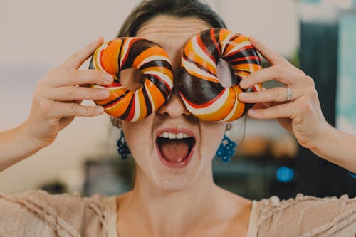 Close-Up Shot of a Person Holding Bagels 