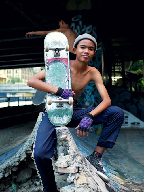 Kid Holding a Skateboard