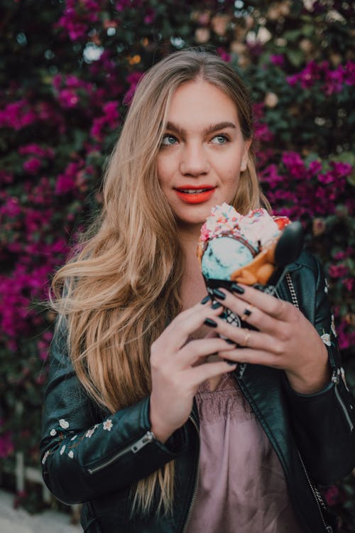 Woman in Black Leather Jacket Holding Ice Cream Cone