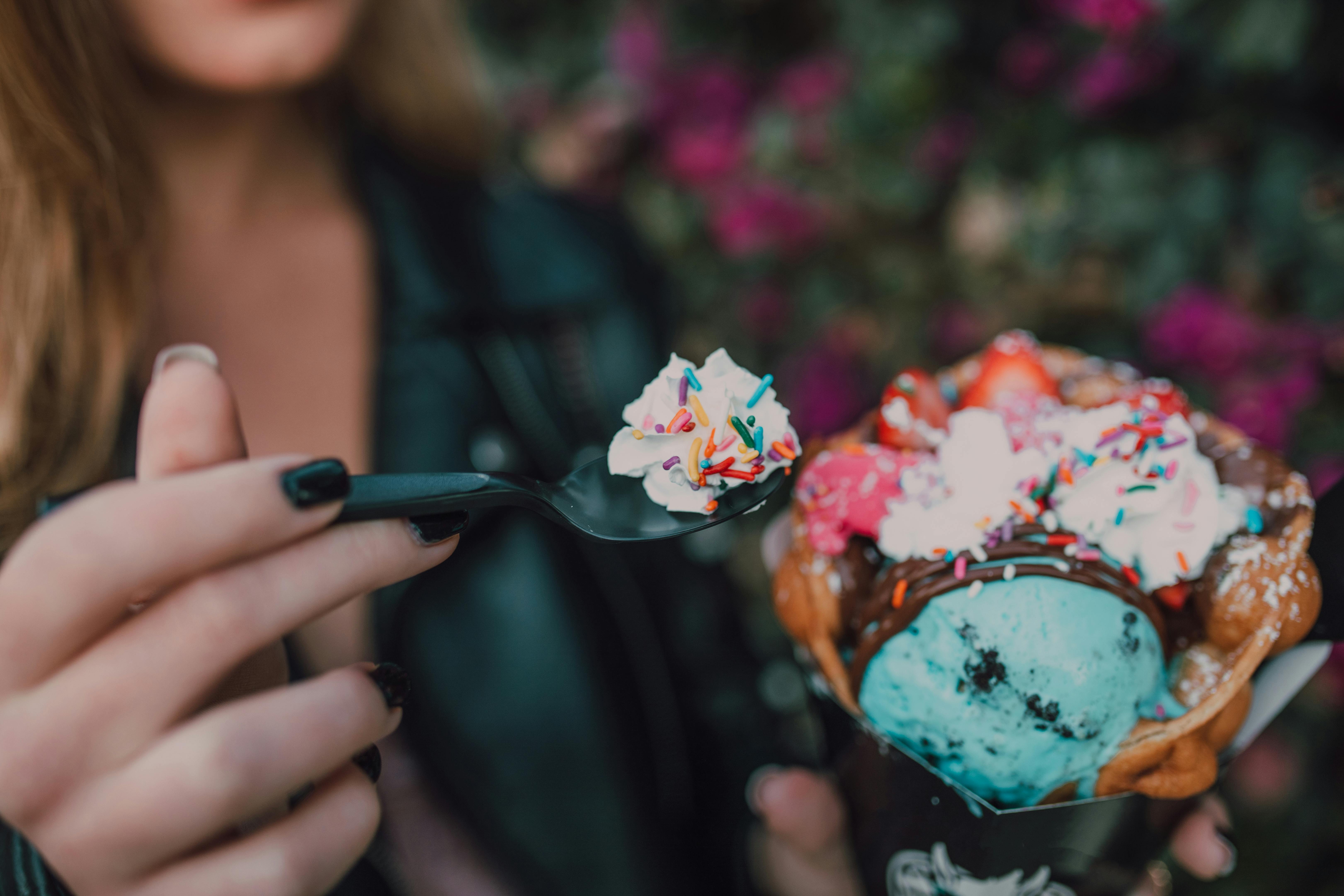 woman holding spoon with ice cream