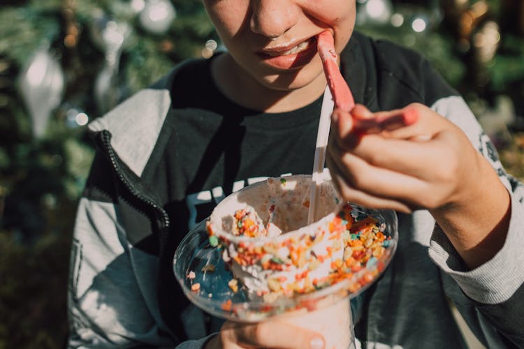 Close-Up Shot Of A Person Eating Dessert