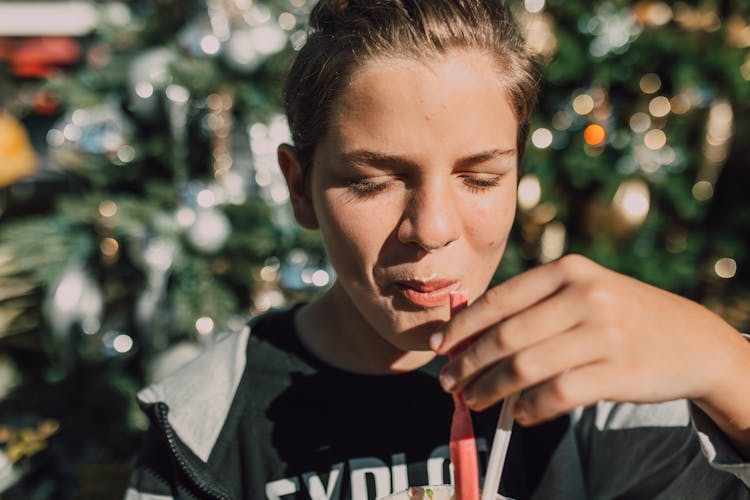 Close-Up Shot Of A Boy Eating Dessert