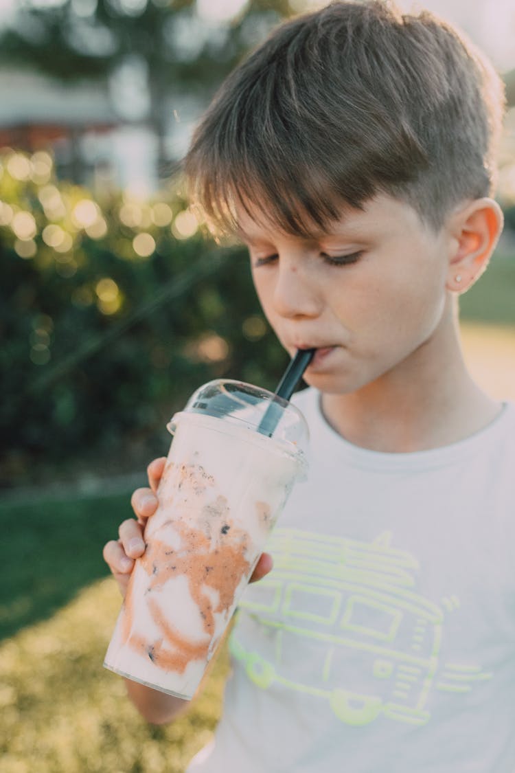 A Young Boy Drinking Milkshake