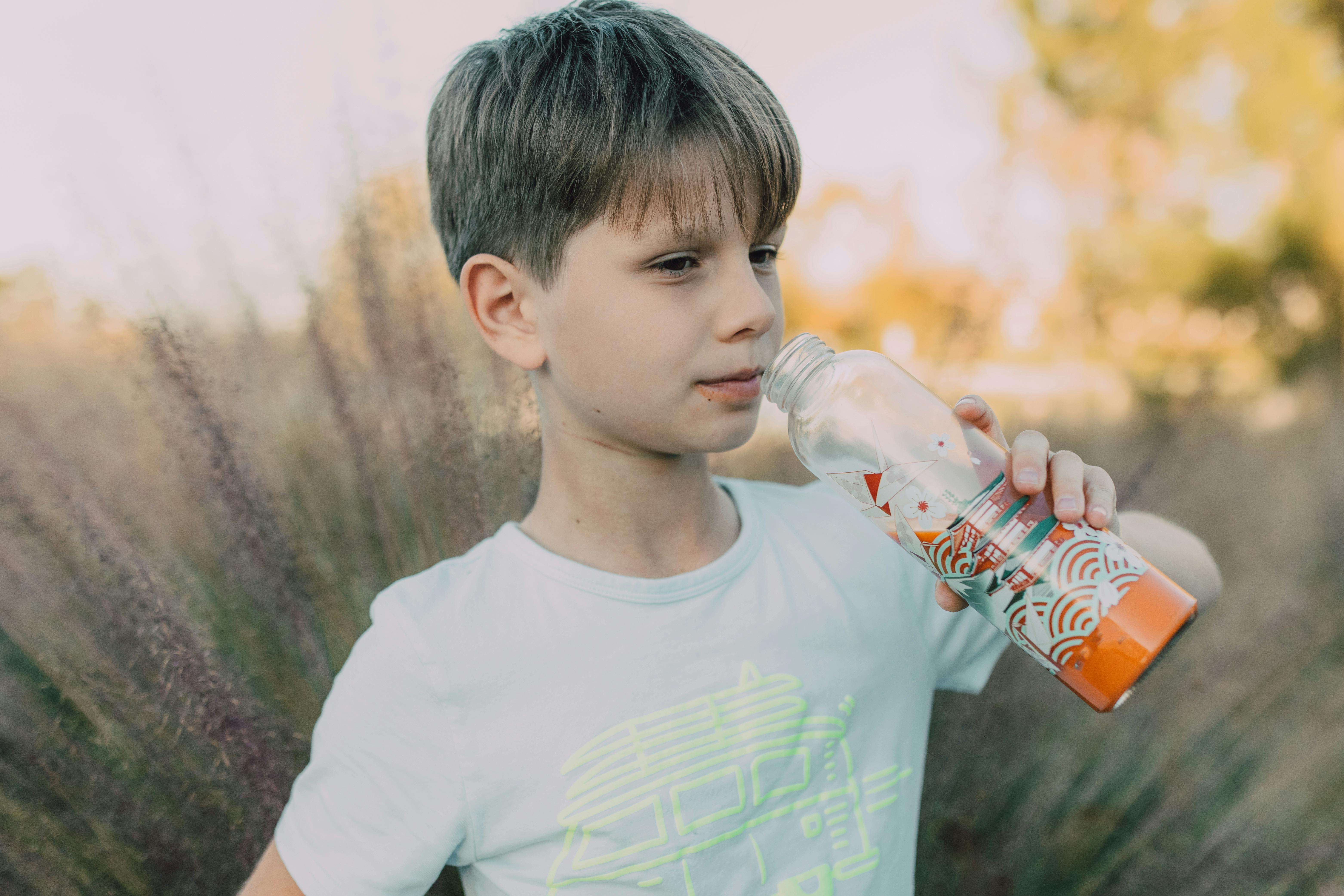 Baby boy drinking with water bottle - Stock image #24733954