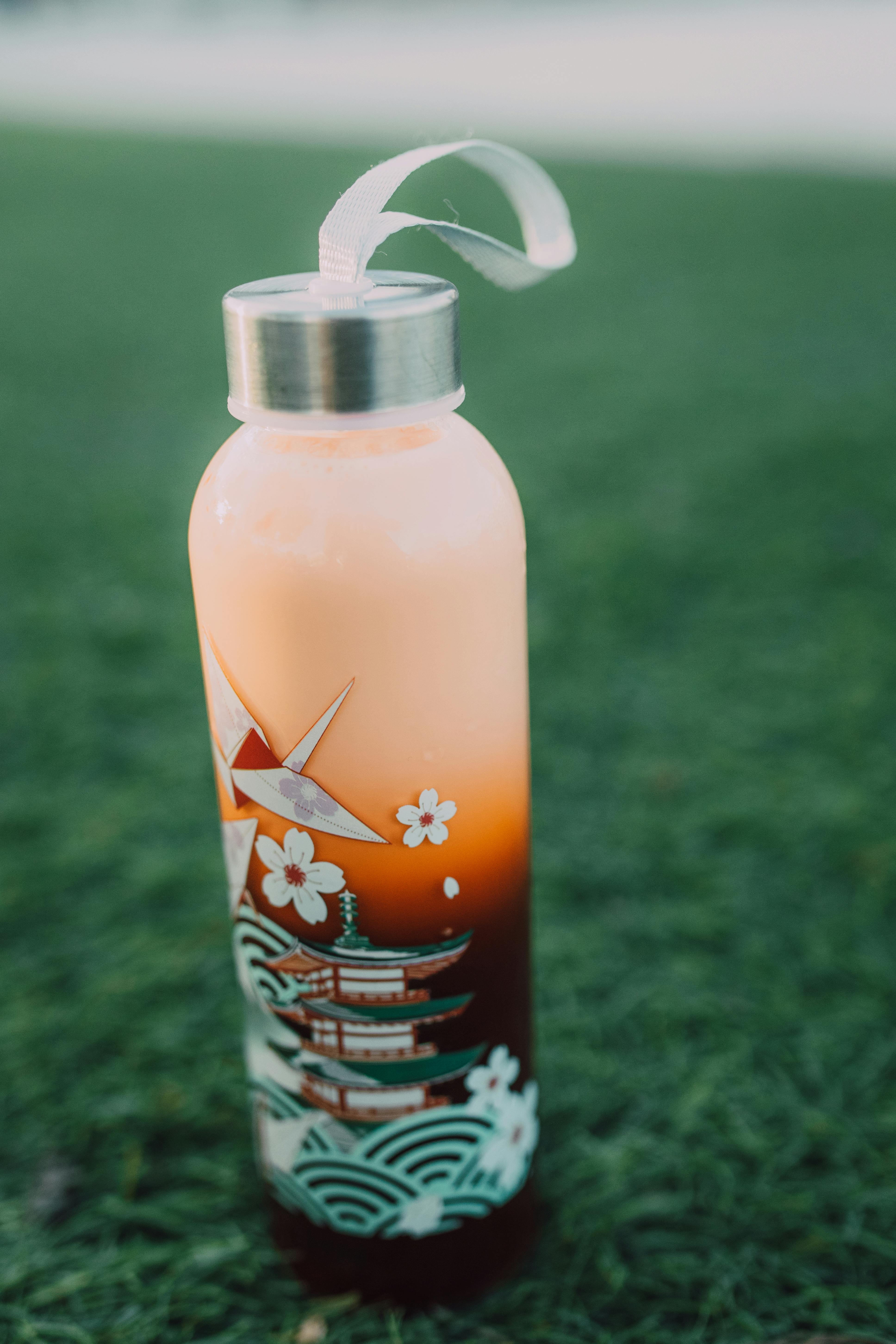 white and red floral plastic bottle