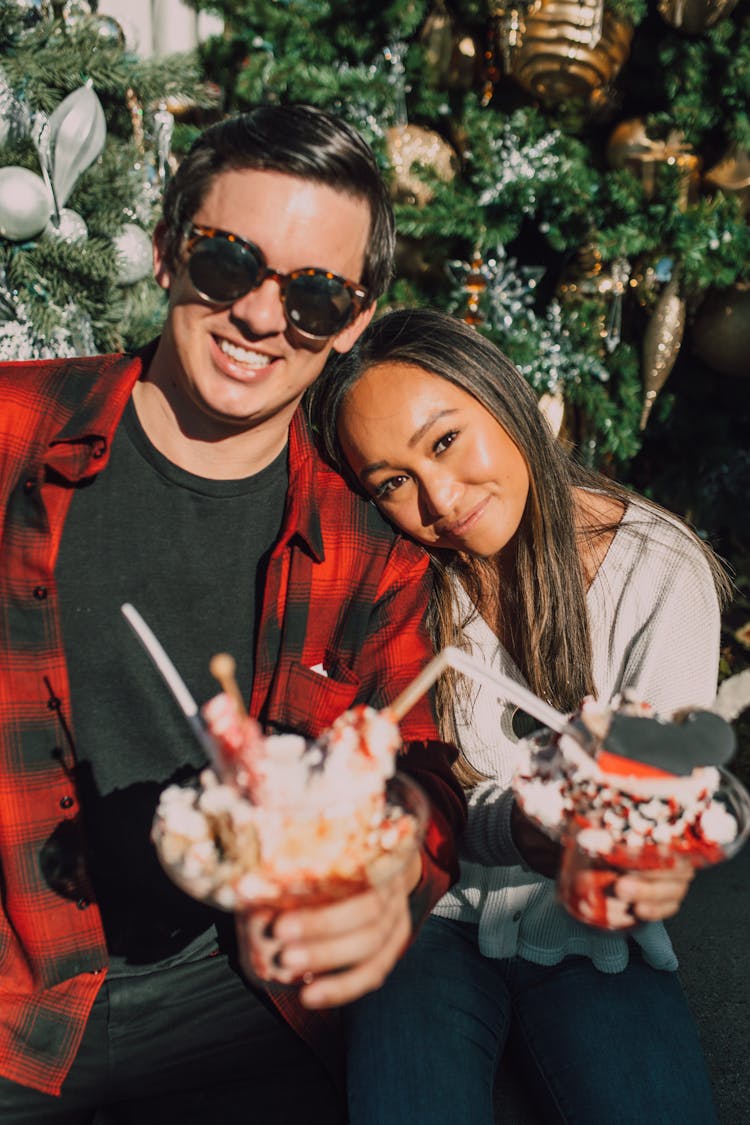 A Man And A Woman Holding Ice Cream