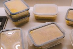 From above of delicious dishes in plastic containers placed on table in kitchen