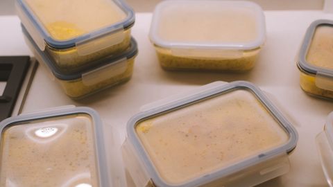 From above of delicious dishes in plastic containers placed on table in kitchen