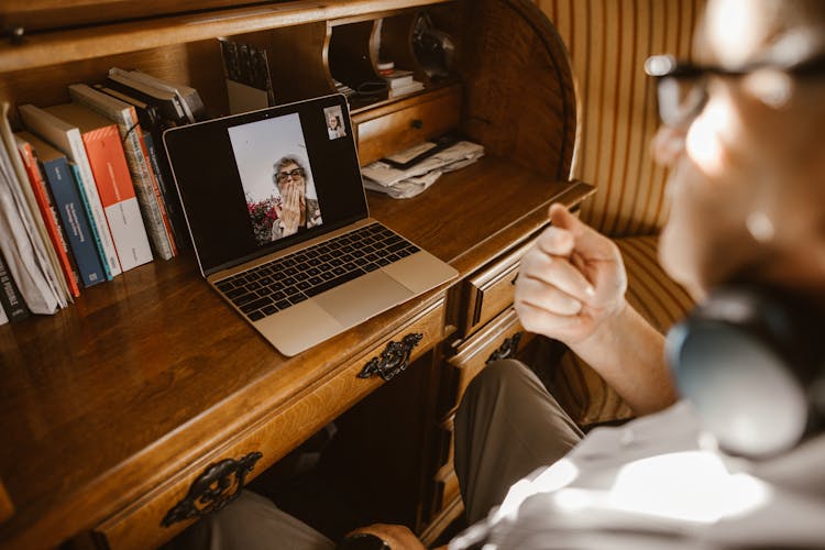 A Person Having A Video Call On A Laptop