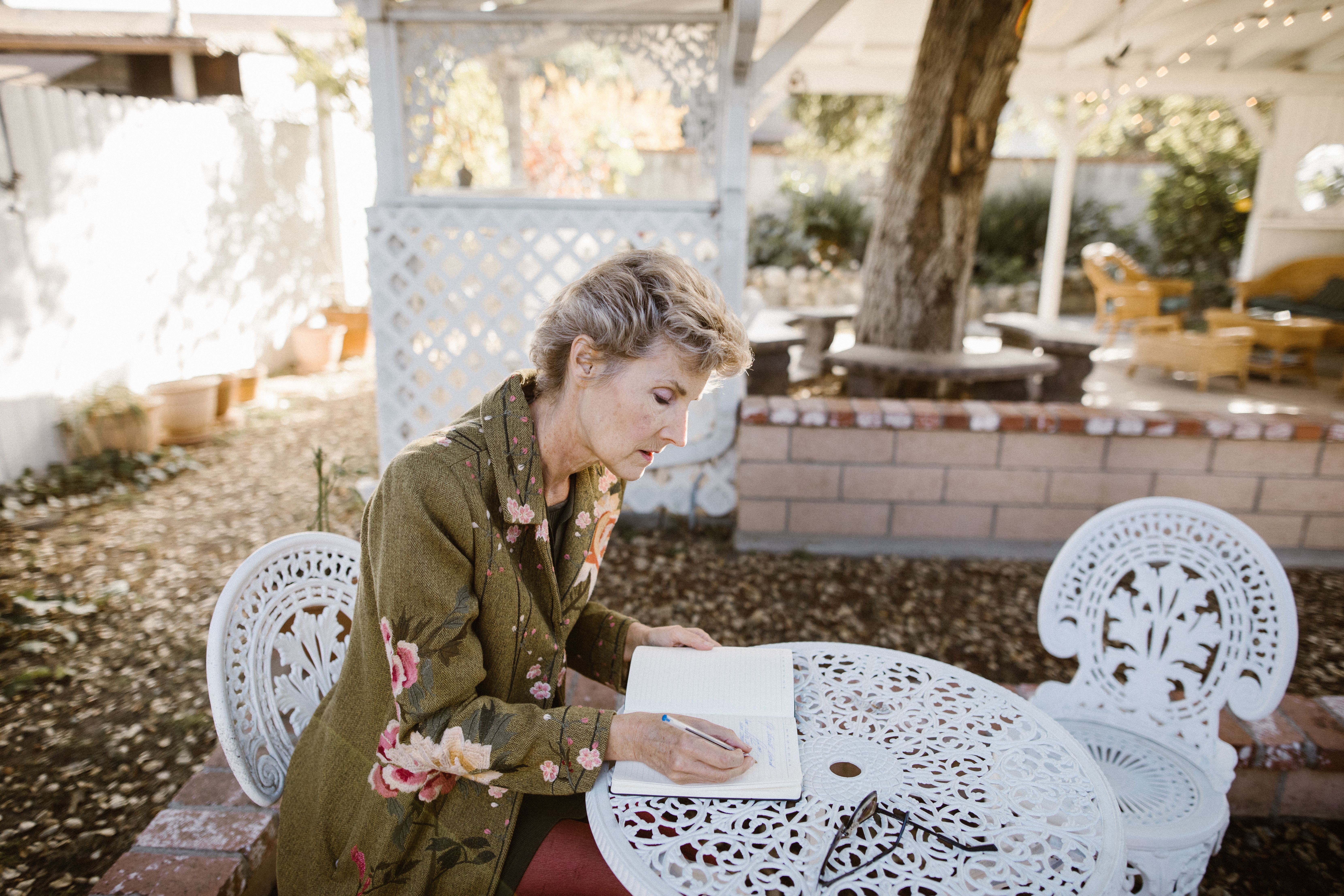 person journaling in a quiet garden setting to process emotions - what to do when alcoholic spouse relapses