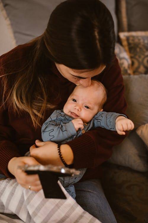 Free Mother Kissing Her Baby Stock Photo