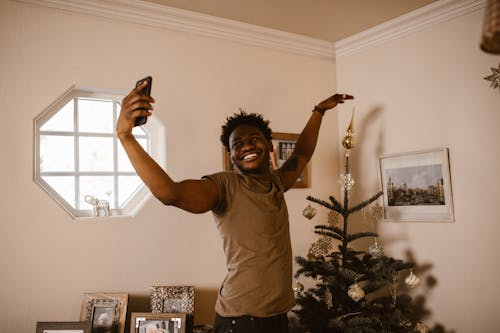 Smiling Man Having a Video Call Using a Cellphone