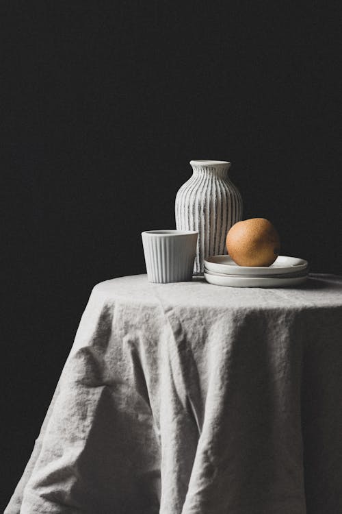 Free Photo of a Pear Near a Vase Stock Photo