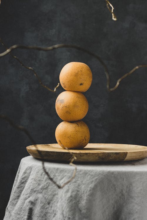 A Stack of Pears on a Wooden Board 