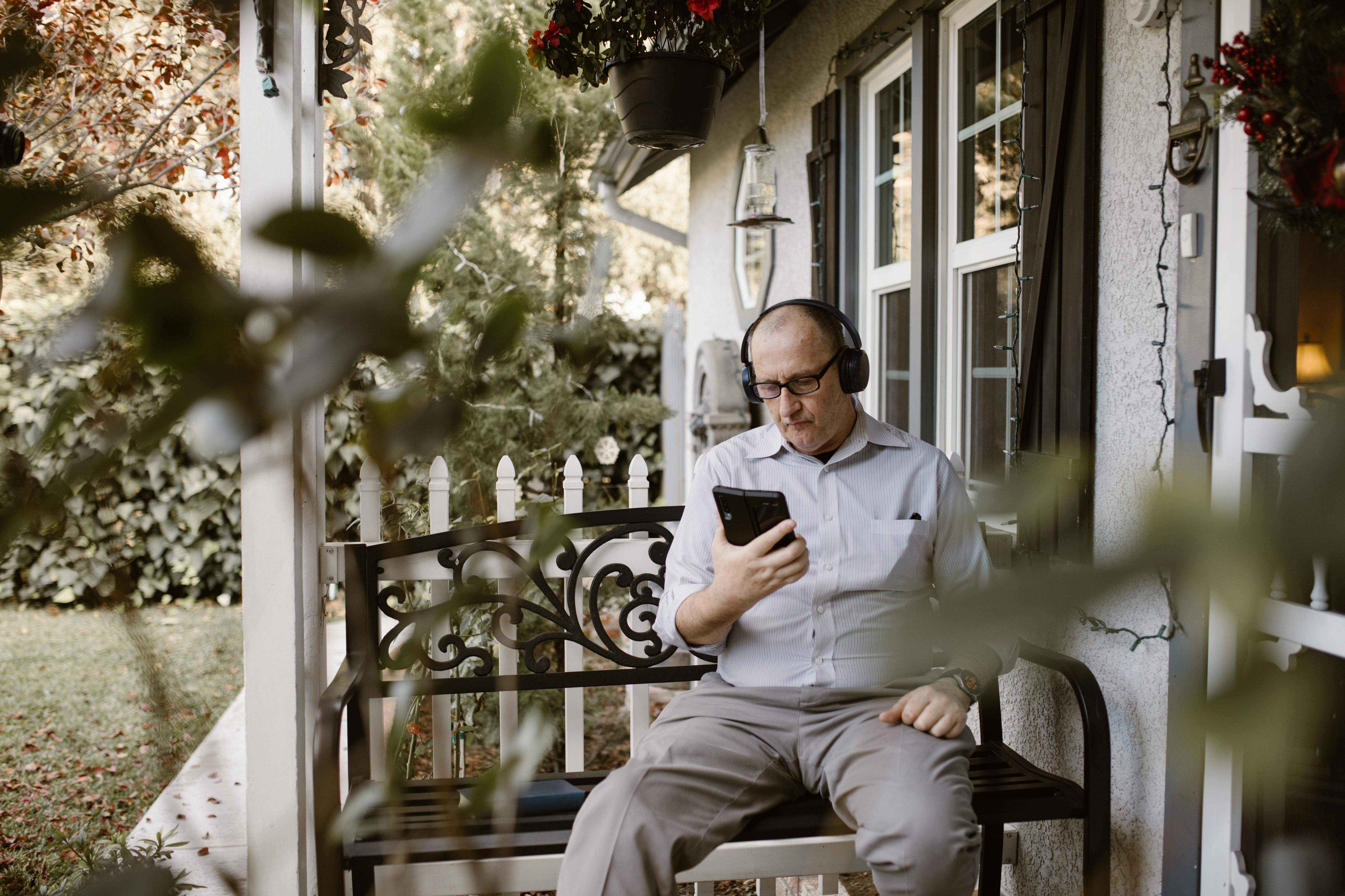 man in white dress shirt and gray pants sitting on black armchair