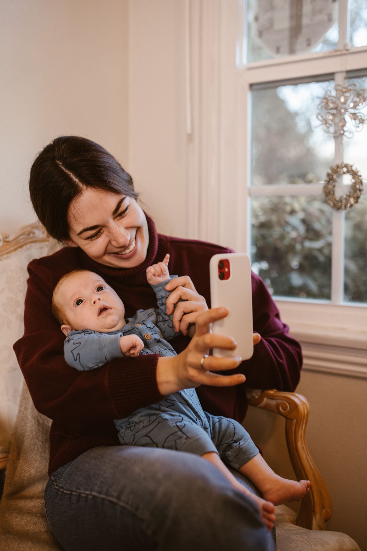 Mother recording a video of her baby on a phone