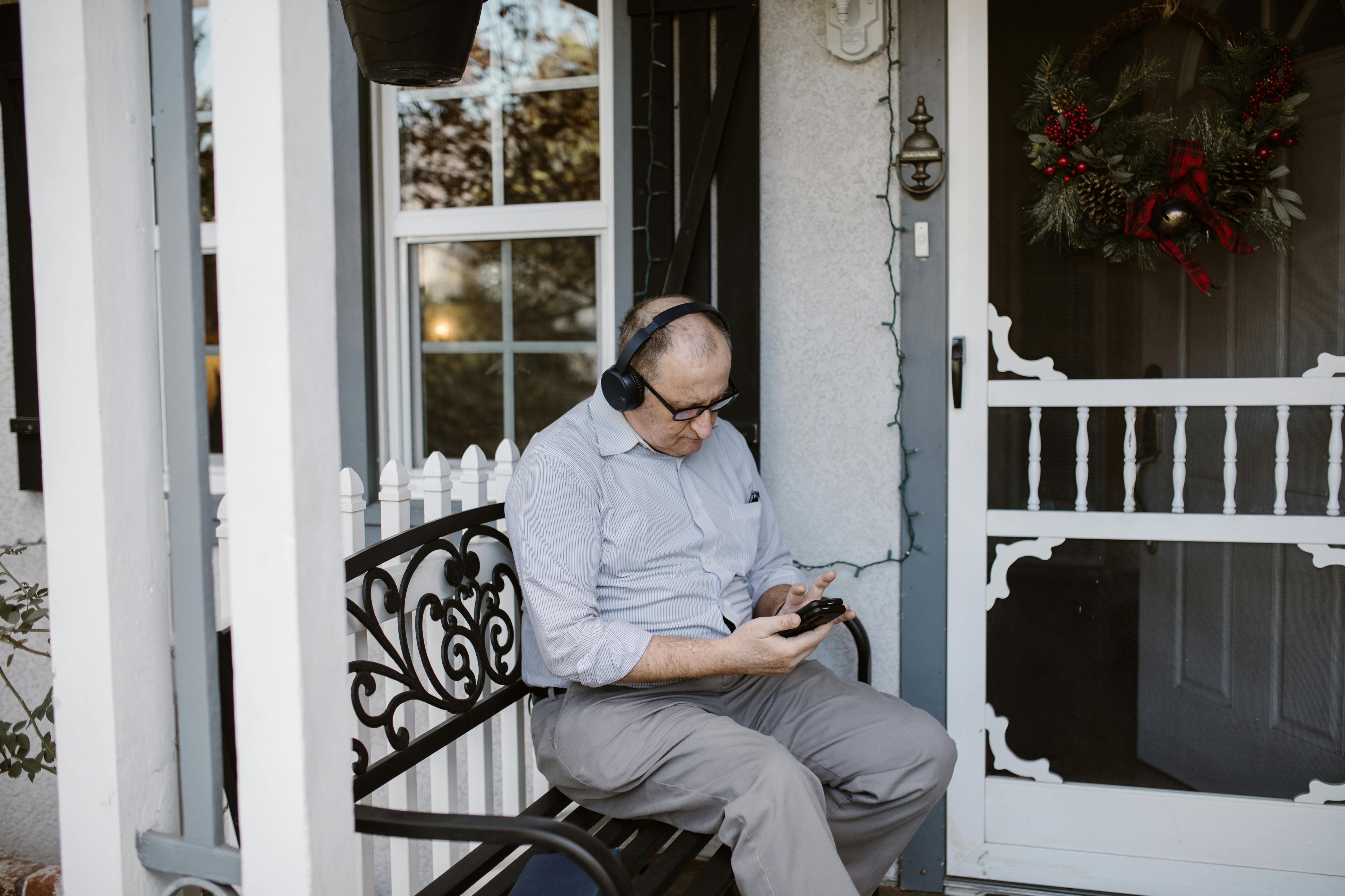 man in white dress shirt and gray pants sitting on black armchair