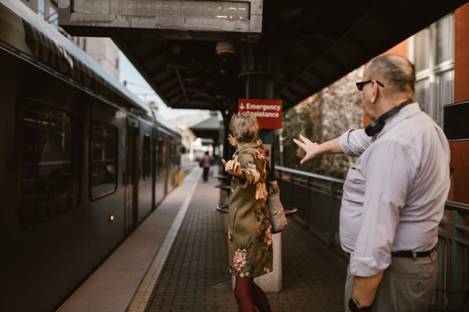 Two people beside a train on a station platform