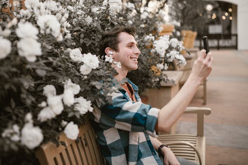 Ücretsiz adam, Ahşap bank, Beyaz çiçekler içeren Ücretsiz stok fotoğraf Stok Fotoğraflar