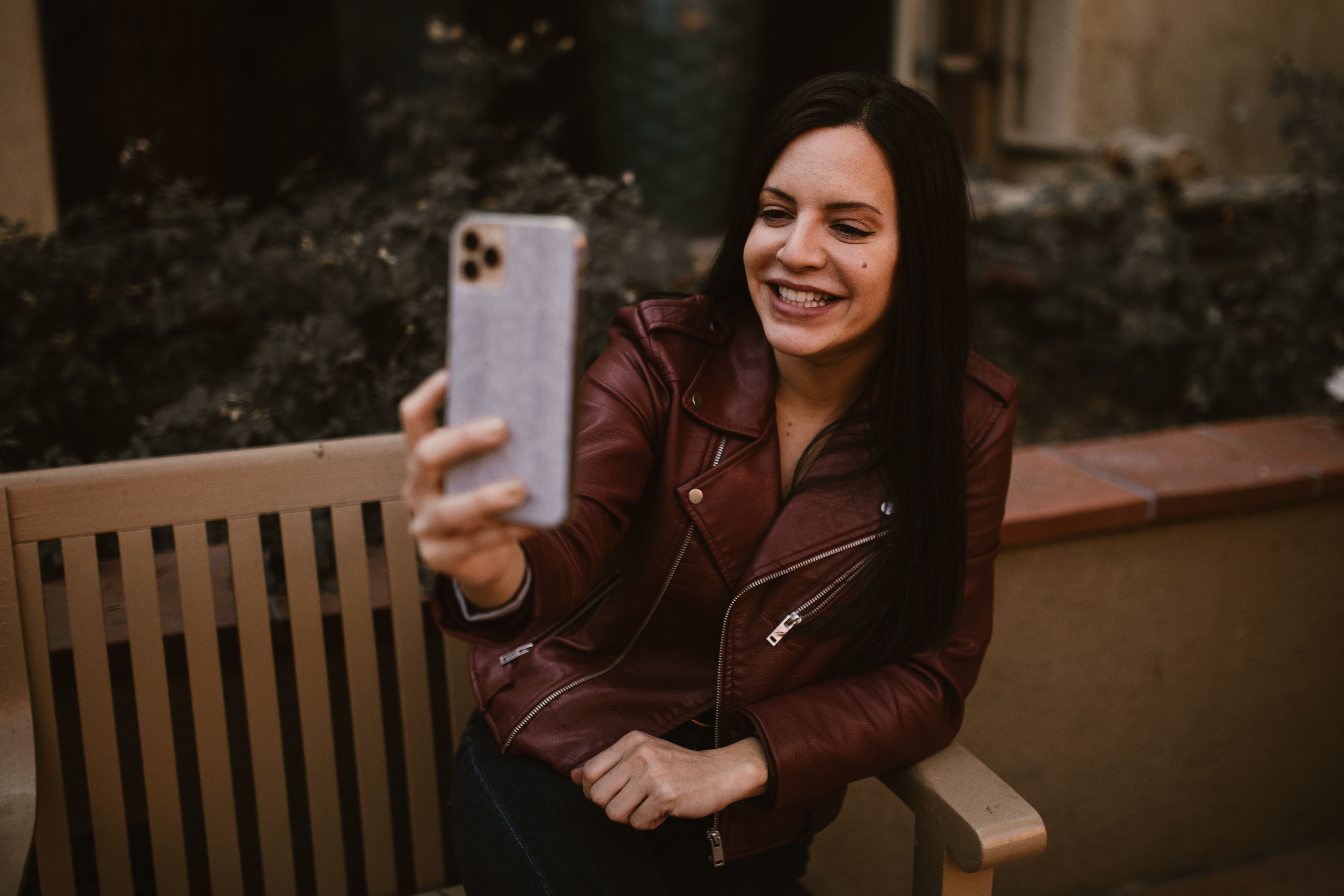 A Woman in Brown Leather Jacket Talking on the Phone · Free Stock Photo