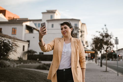 Woman in Beige Jacket and Black Skirt