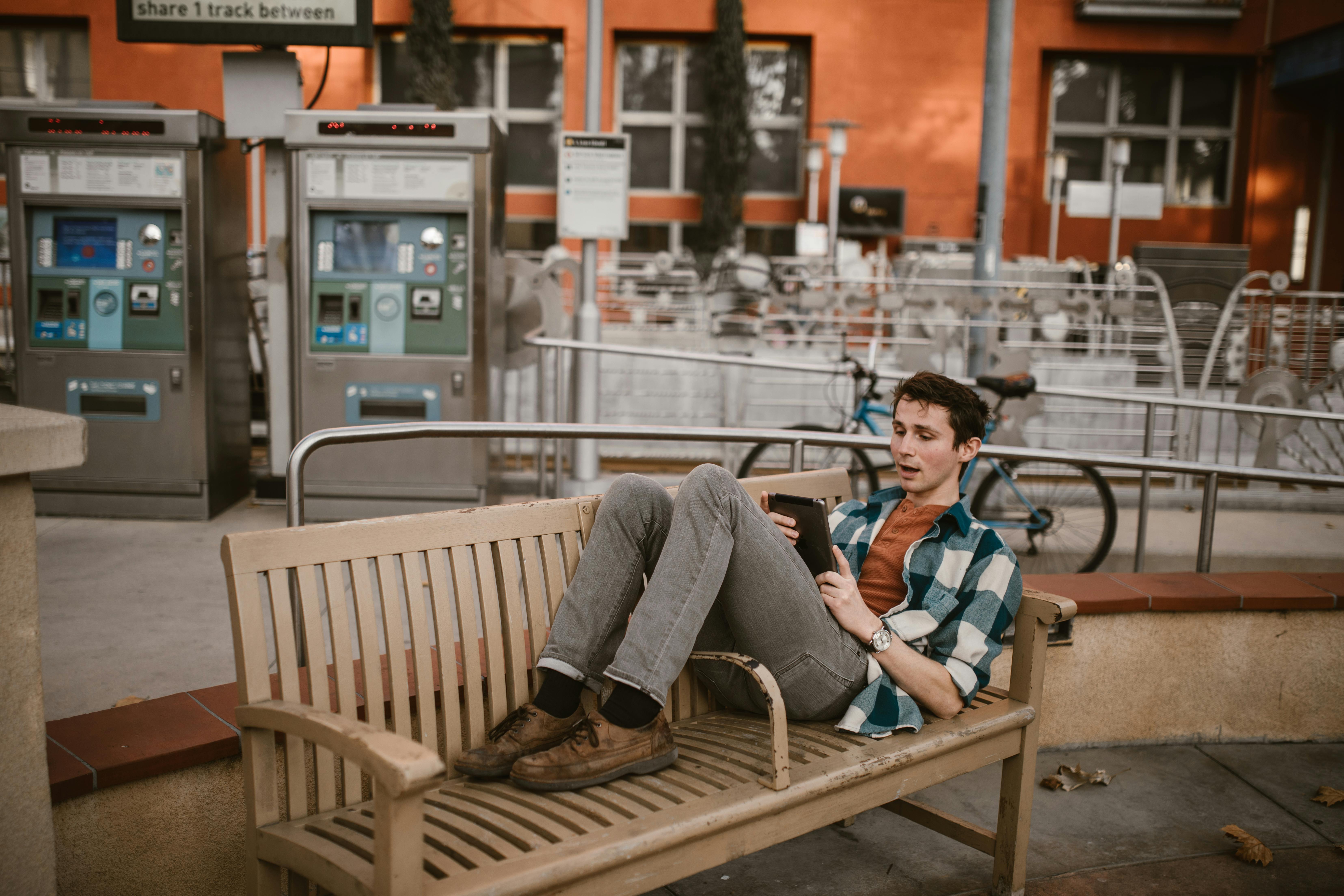 man and woman sitting on bench