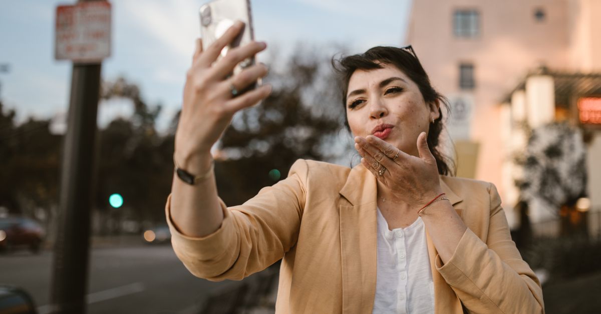 Hispanic woman on smartphone reviewing WhatsApp insurance quote in Lakeland Florida car
