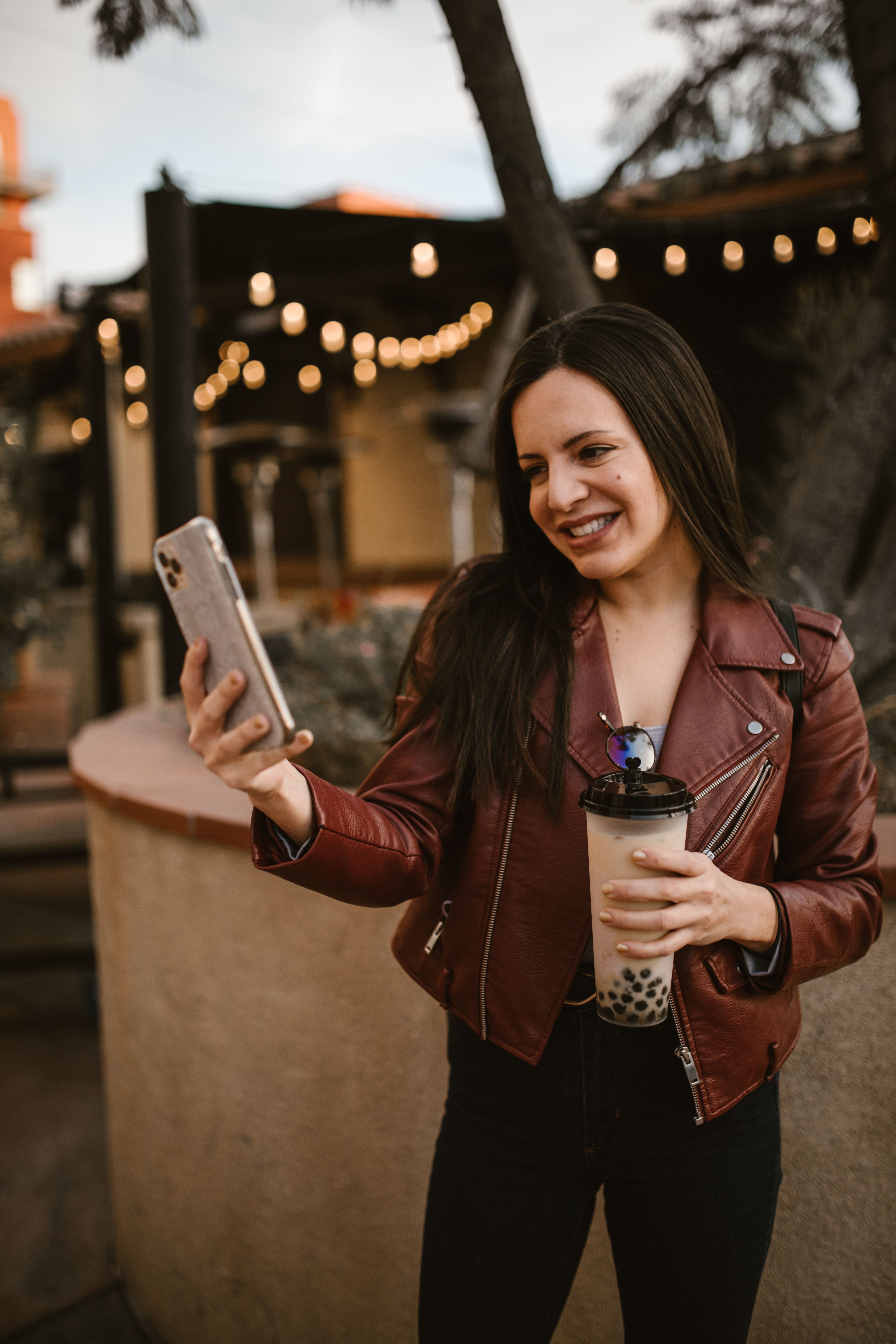A Woman in Brown Leather Jacket Talking on the Phone · Free Stock Photo