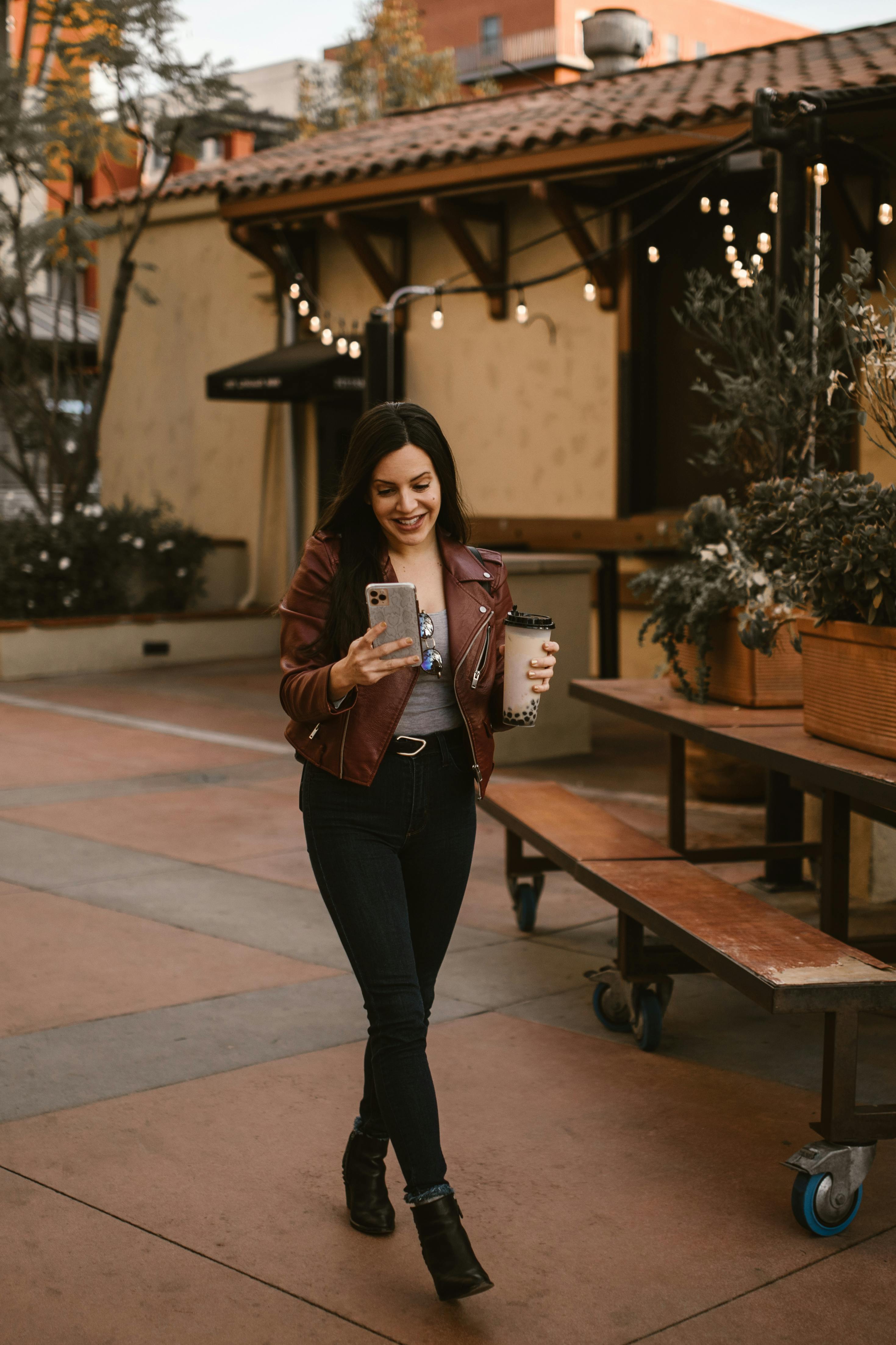 a woman walking on the street while talking on the phone