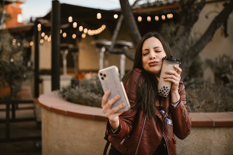 A Woman Taking Selfie With Her Drink