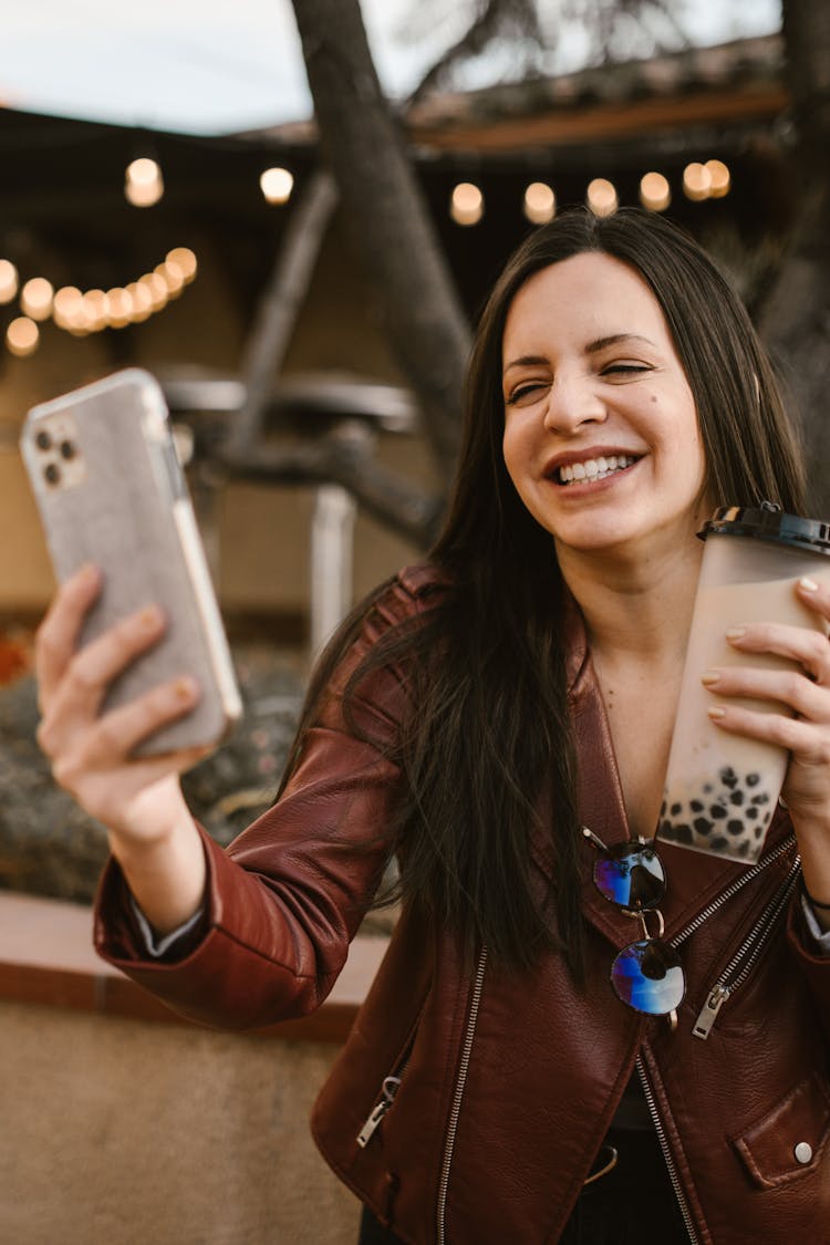 A Woman Taking Selfie With Her Drink