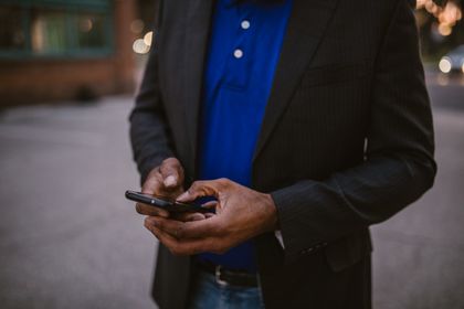 Man in a suit using a phone