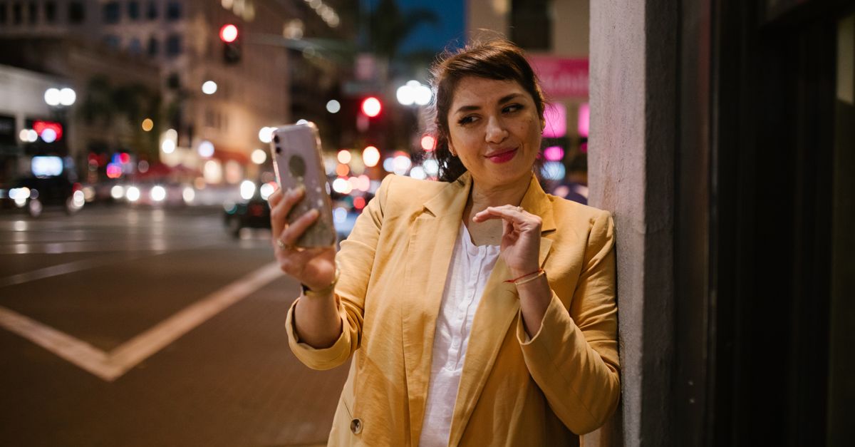 Hispanic woman on smartphone comparing car insurance quotes in Texas city