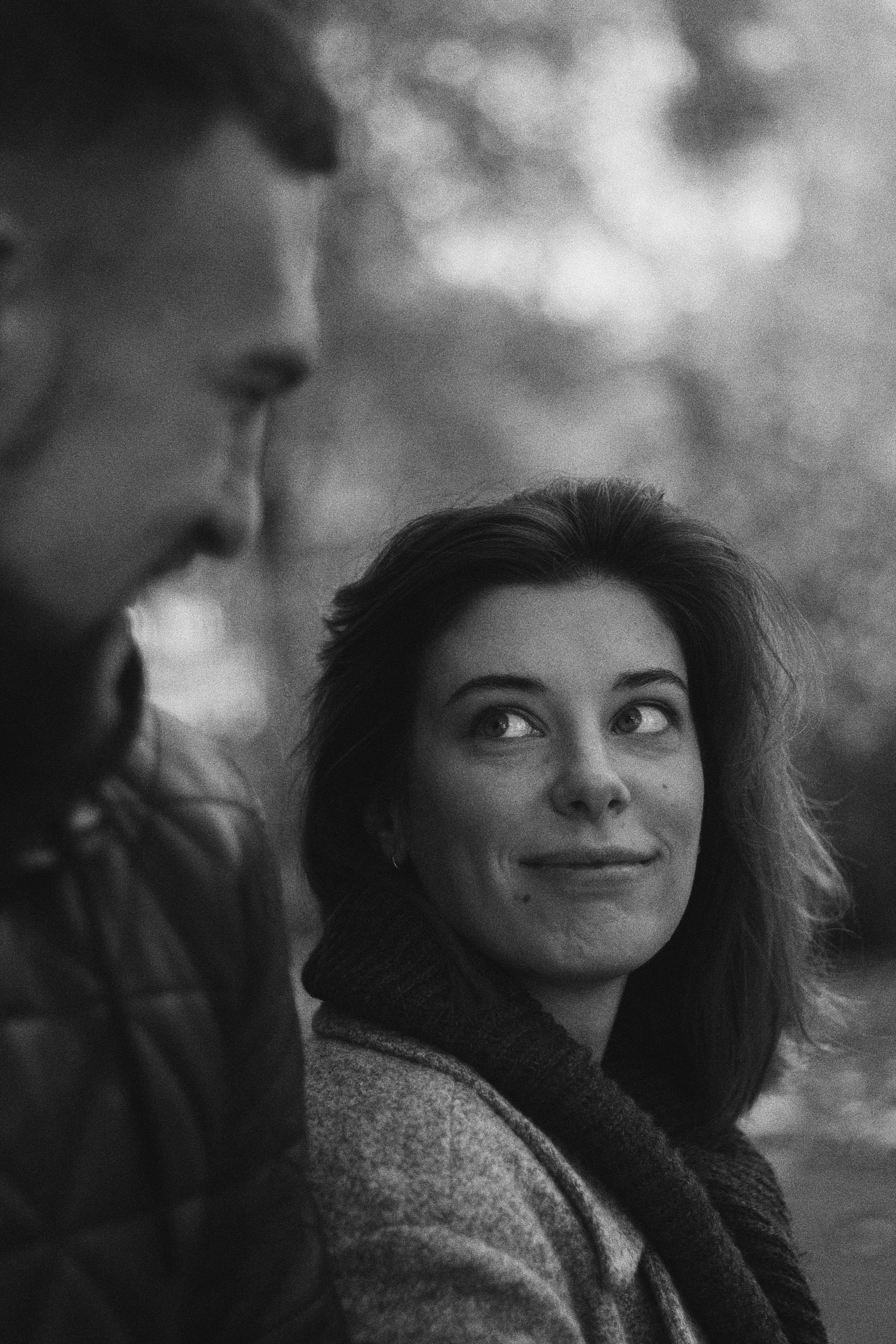 romantic young couple looking at each other while relaxing in park