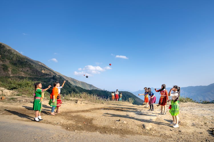 Group Of Kids Playing With Ball In Rural Area