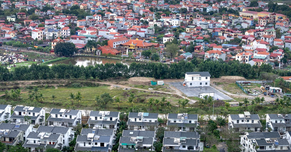 Photo by Quang Nguyen Vinh Drone view modern residential cottages located on grassy suburb district of modern town on summer day
