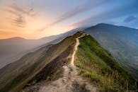 Scenery of narrow footpath on lush hilltop in picturesque highlands
