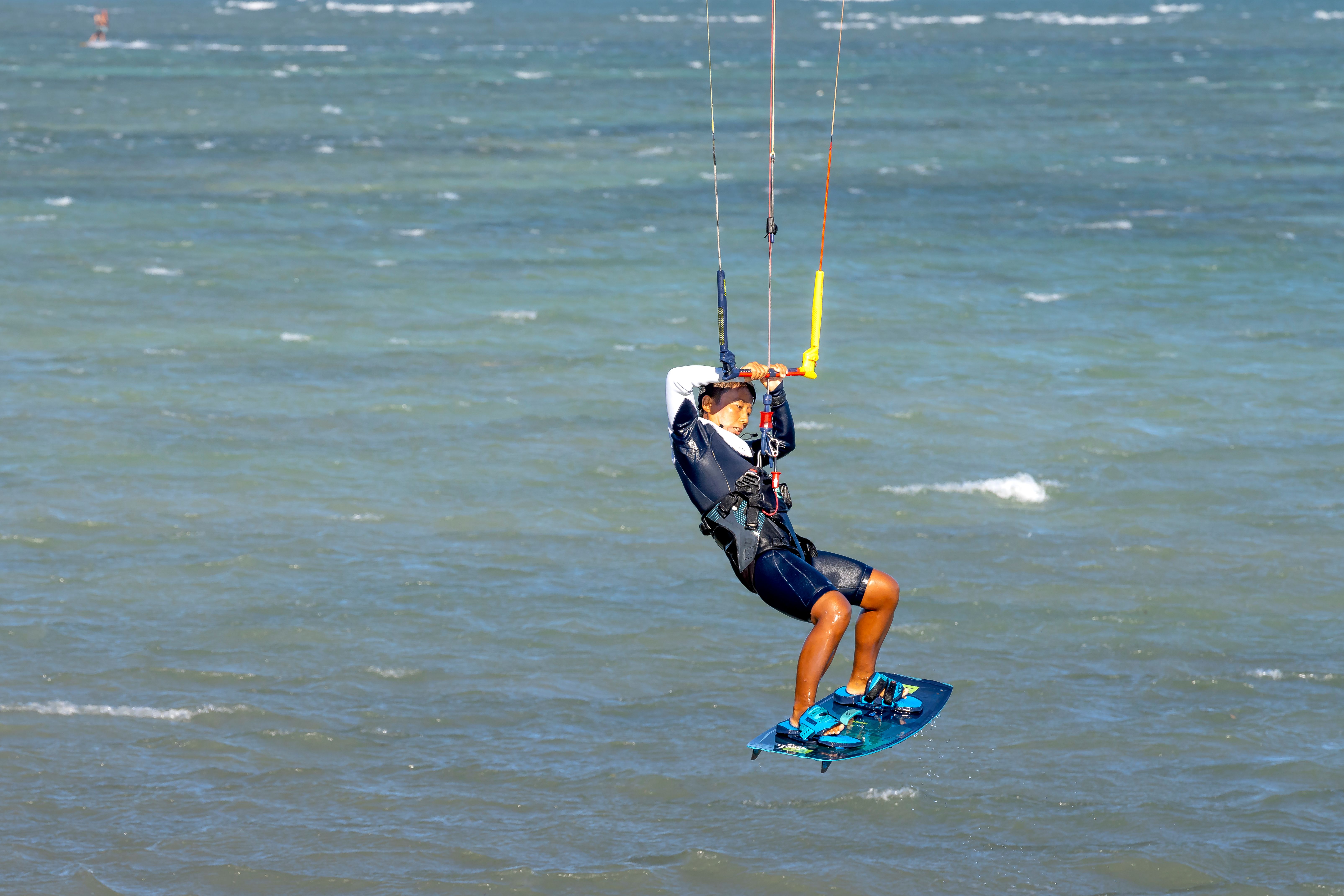 Determined young ethnic guy jumping on board while practicing ...