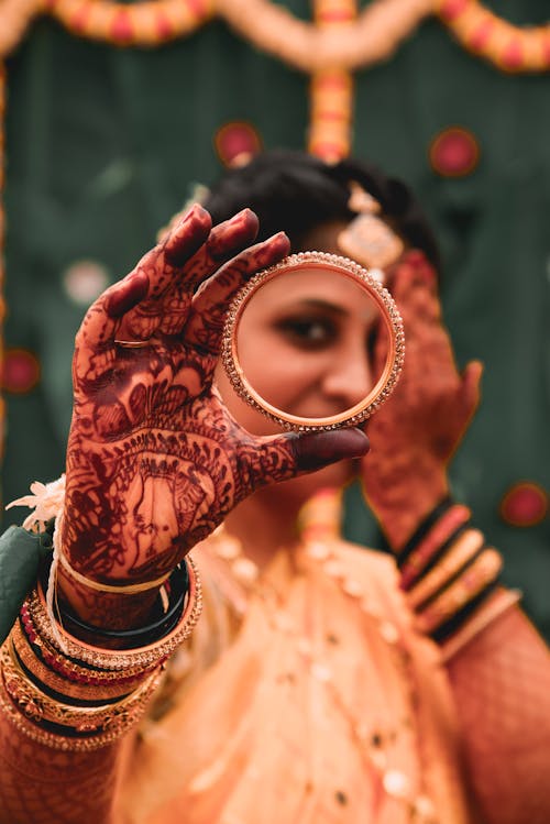 Woman Holding a Gold Bracelet