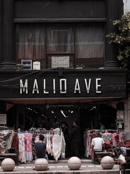 Street view of a busy clothing market in Malioboro, Jogja, Indonesia, showcasing vibrant commerce and local culture.