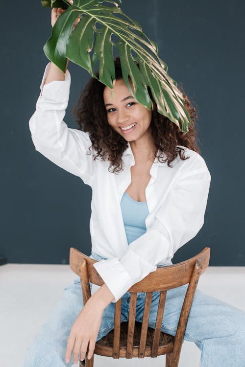 Photo Of Woman Holding Dark Green Leaf